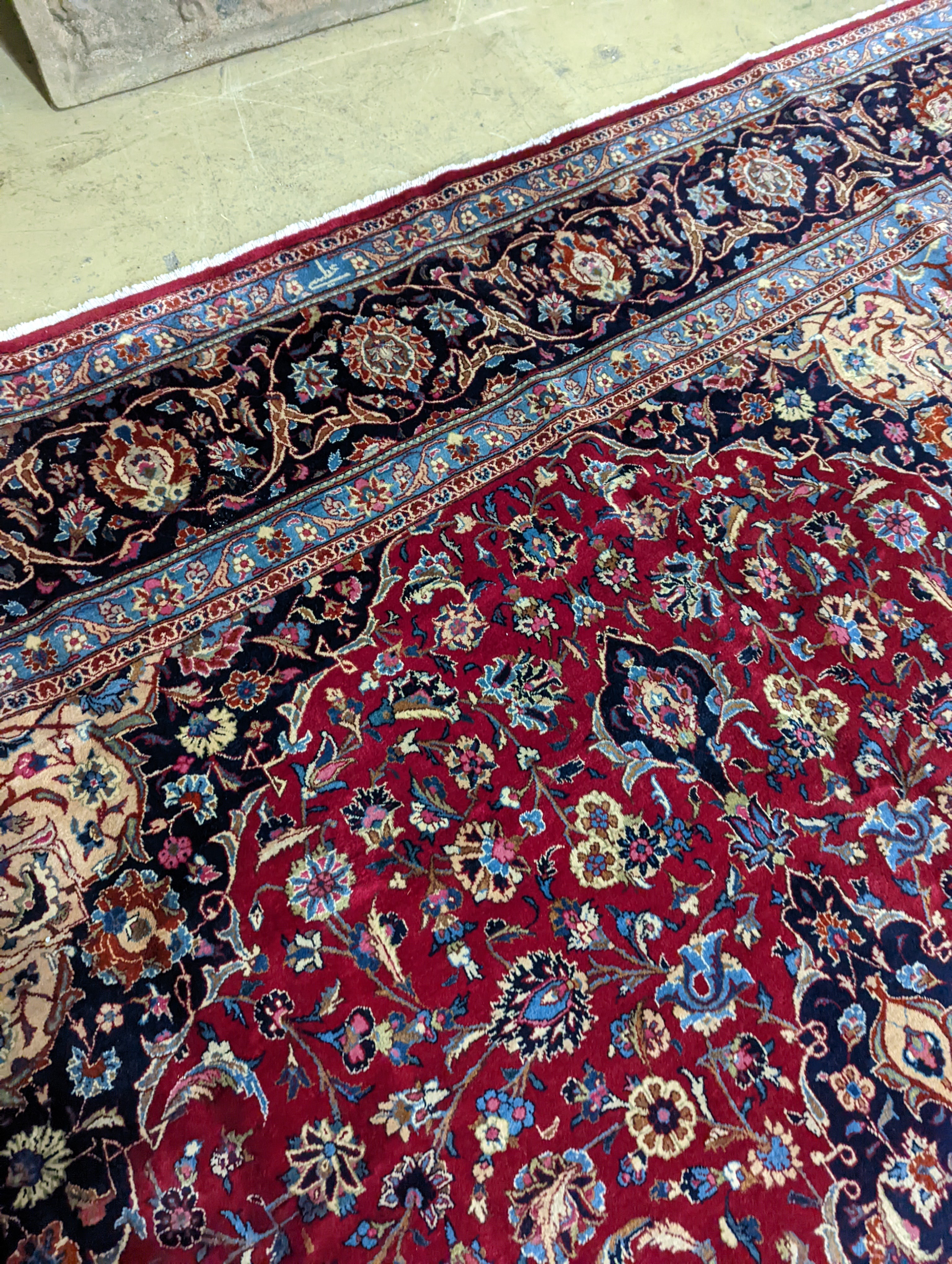 A Kashan burgundy ground carpet, 380 x 300cm